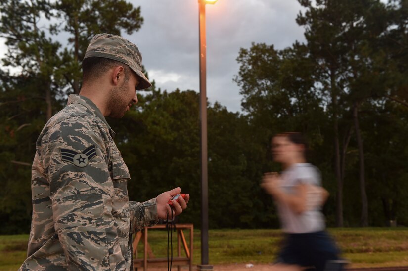 Senior Airman Shadi Zahed, 628th Force Support Squadron sports program manager times Senior Airman Victoria Medina Echeverria, 628th FSS fitness programs manager, during a mock physical training test on the track at Joint Base Charleston, S.C., Oct. 11, 2017.