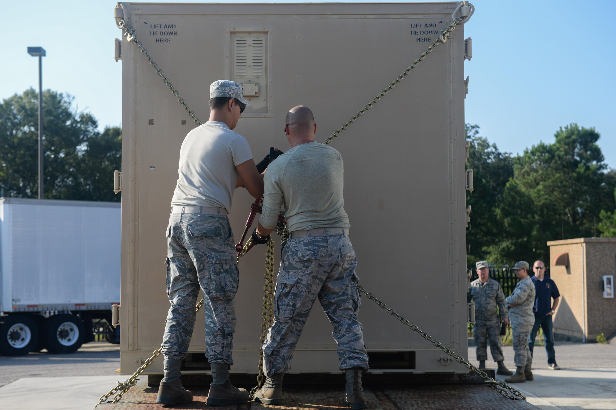 Senior Airman Christian Bonenberger, 85th Engineering Installation Squadron material control manager and Staff Sgt. Victor Mancaruso, 85th EIS vehicle operator, secure a cargo container for a deployment to aid Puerto Rico at the 85th EIS Vehicle Operations building on Keesler Air Force Base, Mississippi. In the wake of Hurricane Maria, Puerto Rico’s land mobile radio communications infrastructure for first responders are in dire need of repair and the 85th EIS were requested by name to help get it back up and running. (U.S. Air Force photo by Senior Airman Travis Beihl)