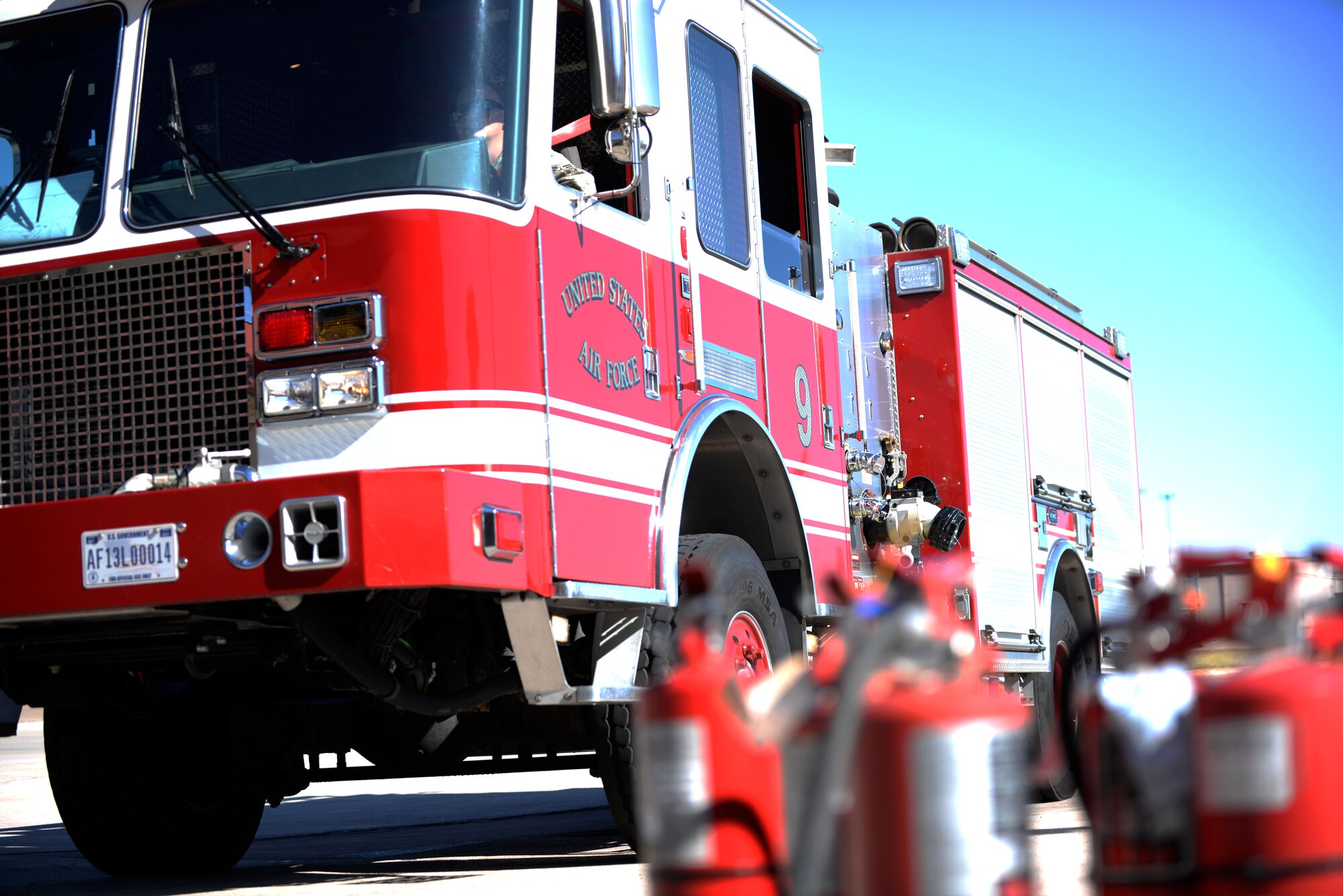 The 28th Civil Engineer Squadron Fire Protection Flight fire truck pulls in to the base fire station after the Fire Prevention Week Parade at Ellsworth Air Force Base, S.D., Oct. 7, 2017. First responders and the base community participated in a parade driving through base and throwing candy to attendees.  (U.S. Air Force photo by Airman 1st Class Thomas Karol)