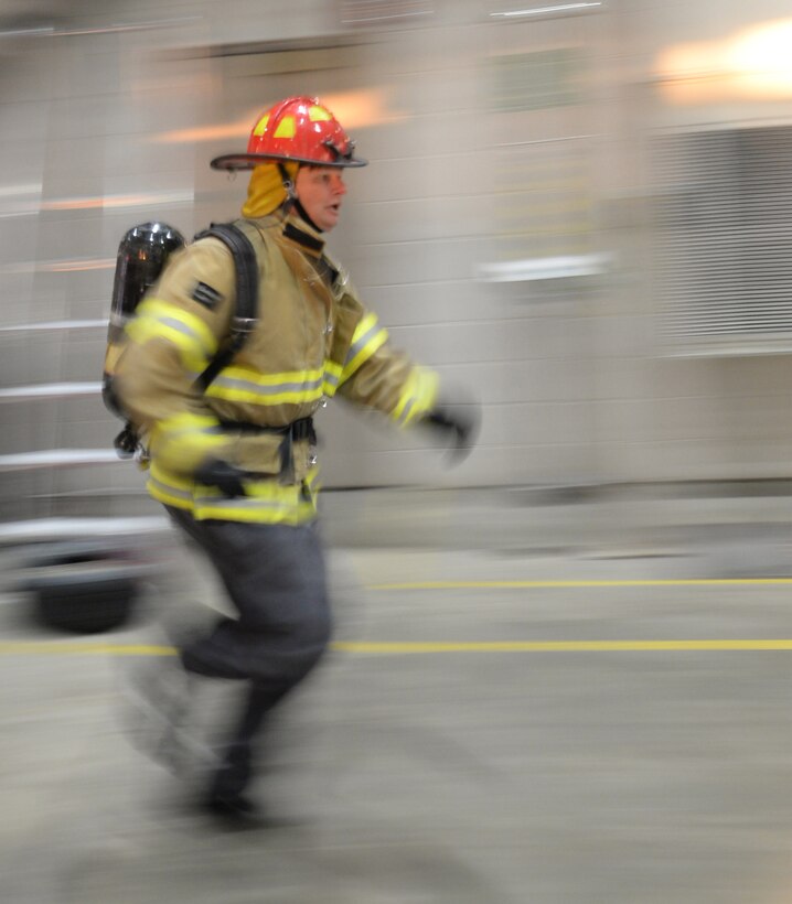 David Olson, the 28th Civil Engineer Squadron Fire Protection Flight chief, runs between obstacles during the Firefighter Challenge at Ellsworth Air Force Base, S.D., Oct. 6, 2017. During National Fire Prevention Week, multiple teams competed against one another on a course designed to test the strength, agility and precision of each member in the four-person teams. (U.S. Air Force photo by Airman 1st Class Thomas Karol)