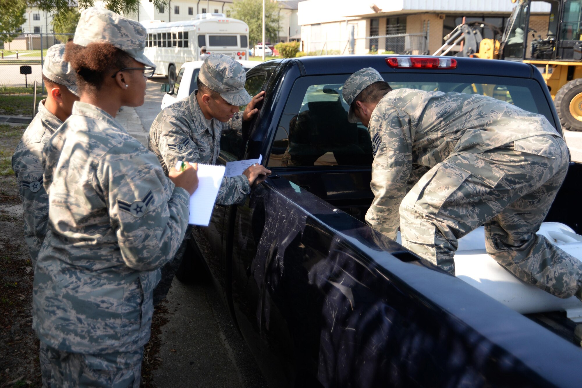 Tech. Sgt. Guillermo Gutierrez, 81st Logistics Readiness Squadron fleet management and analysis NCO in charge, briefs Airmen on how to install a propane kit Oct. 13, 2017, on Keesler Air Force Base, Mississippi. Thirteen vehicles were selected to have propane kits installed as part of a year-long Defense Department study to determine the environmental effects of using propane instead of gasoline in vehicles. (U.S. Air Force photo by Airman 1st Class Suzanna Plotnikov)