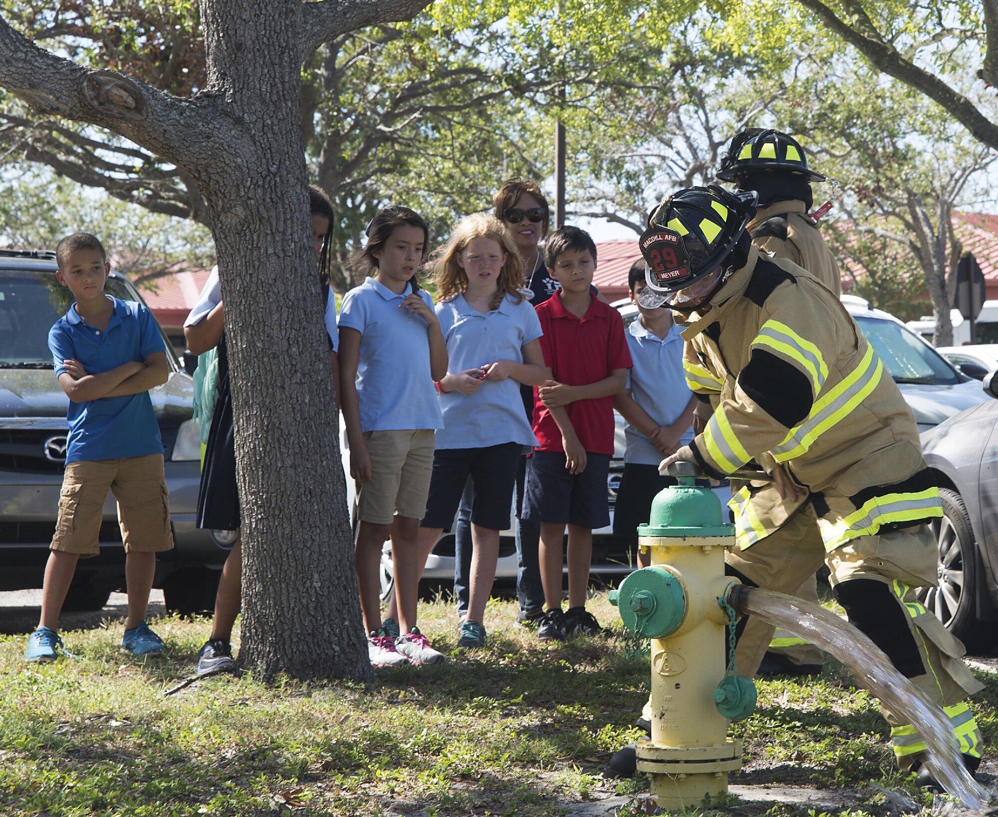 U.S. Air Force Airman 1st Class, Nathan Meyer, a firefighter with the 6th Civil Engineer Squadron, opens a fire hydrant to demonstrate what happens during an actual fire at MacDill Air Force Base, Fla. Oct. 12, 2017.