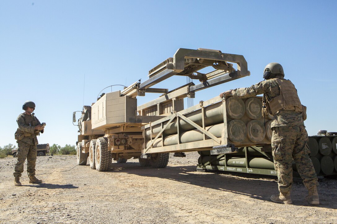 Sgt. Jansen Davis (right), a section chief with 3rd Platoon, Rocket Battery F, 2nd Battalion, 14th Marine Regiment, 4th Marine Division, Marine Forces Reserve, and Lance Cpl. Justin Minor (left), a gunner with 2/14, operate a High Mobility Artillery Rocket System during the unloading of a trainer launch pod and then loading M31 Guided Multiple Launch Rocket Systems munitions into the M142 HIMARS carrier, during Weapons and Tactics Instructor course 1-18 at Landing Zone Bull Attack, near the Chocolate Mountain Aerial Gunnery Range, California, Oct. 11, 2017. The Reserve Marines are participating in WTI 1-18 during their annual training to maintain proficiency and experience with the HIMARS, advancing their combat effectiveness and readiness for future exercises and deployments. (U.S. Marine Corps photo by Cpl. Dallas Johnson/Released)