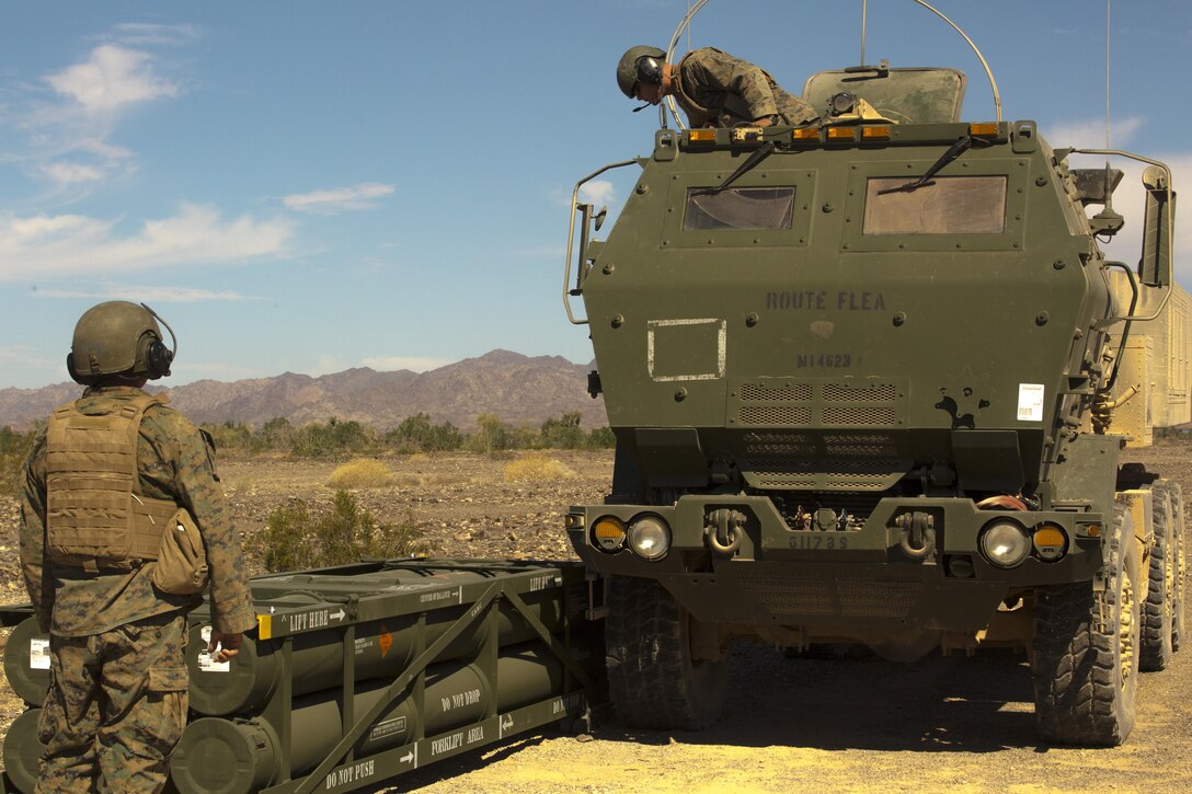 Sgt. Jansen Davis (left), a section chief, and Lance Cpl. Justin Minor (right), a gunner, both with 3rd Platoon, Rocket Battery F, 2nd Battalion, 14th Marine Regiment, 4th Marine Division, Marine Forces Reserve, align the M142 High Mobility Artillery Rocket System next to Guided Multiple Launch Rocket System munitions during Weapons and Tactics Instructor course 1-18 at Landing Zone Bull Attack, near the Chocolate Mountain Aerial Gunnery Range, California, Oct. 11, 2017.