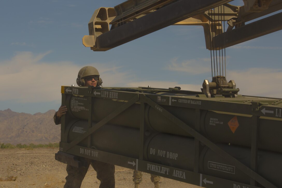 Sgt. Jansen Davis, a section chief with 3rd Platoon, Rocket Battery F, 2nd Battalion, 14th Marine Regiment, 4th Marine Division, Marine Forces Reserve, guides a Guided Multiple Launch Rocket System onto an M142 High Mobility Artillery Rocket System during Weapons and Tactics Instructor course 1-18 at Landing Zone Bull Attack, near the Chocolate Mountain Aerial Gunnery Range, California, Oct.11, 2017.