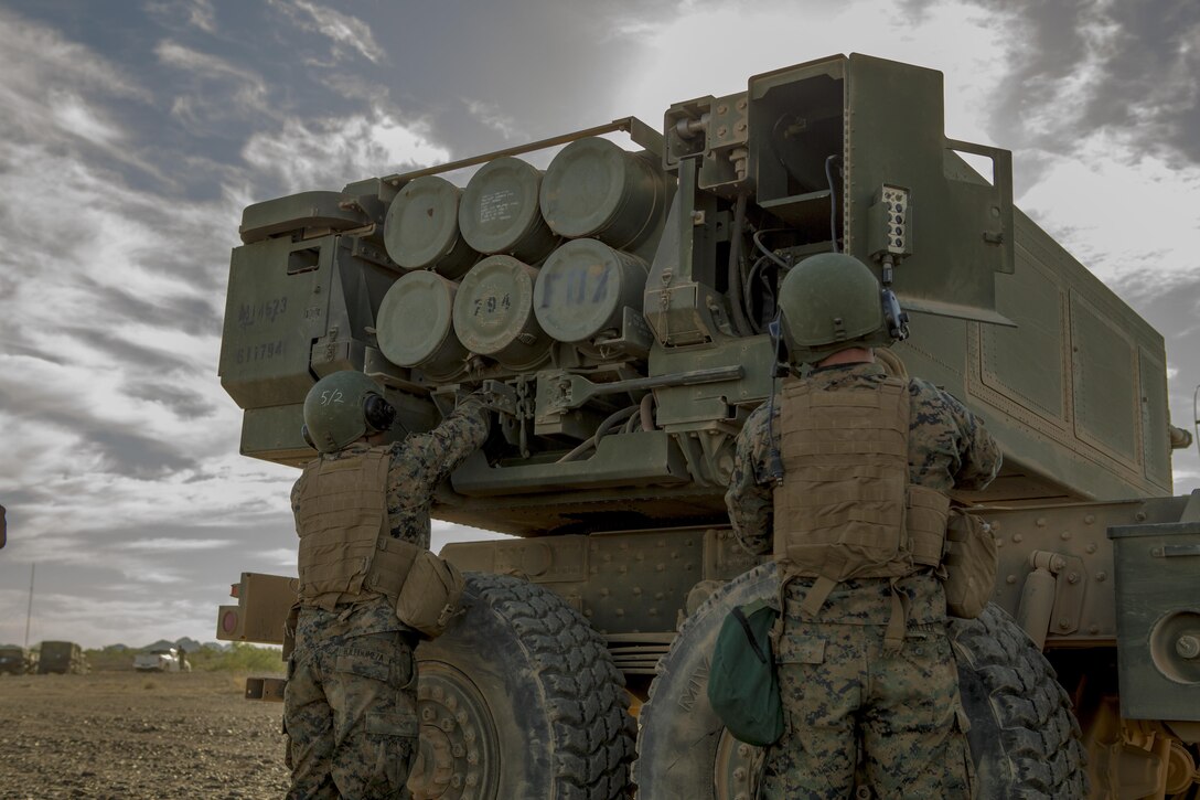 Sgt. Manuel Toledomeza (left), a section chief, and Lance Cpl. Anthony Miller (right), a gunner, both with 3rd Platoon, Rocket Battery F, 2nd Battalion, 14th Marine Regiment, Marine Forces Reserve, secure the wires of the High Mobility Artillery Rocket System to prevent any loose disturbance, at Landing Zone Bull Attack, near the Chocolate Mountain Aerial Gunnery Range, California, Oct. 11, 2017.