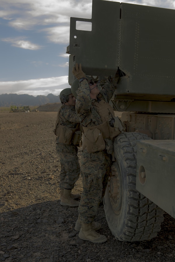 Sgt. Manuel Toledomza (right), a section chief, and Lance Cpl. Anthony Miller, a gunner, both with 3rd Platoon, Rocket Battery F, 2nd Battalion, 14th Marine Regiment, Marine Forces Reserve, adjusts the supply box of a M142 High Mobility Artillery Rocket System during Weapons and Tactics Instructor course 1-18 at Landing Zone Bull Attack, near the Chocolate Mountain Aerial Gunnery Range, California, Oct. 11, 2017. The Marines are participating in WTI 1-18 during their two-week annual training to prepare for future exercises and deployments. (U.S. Marine Corps photo by Lance Cpl. Melany Vasquez/ Released)