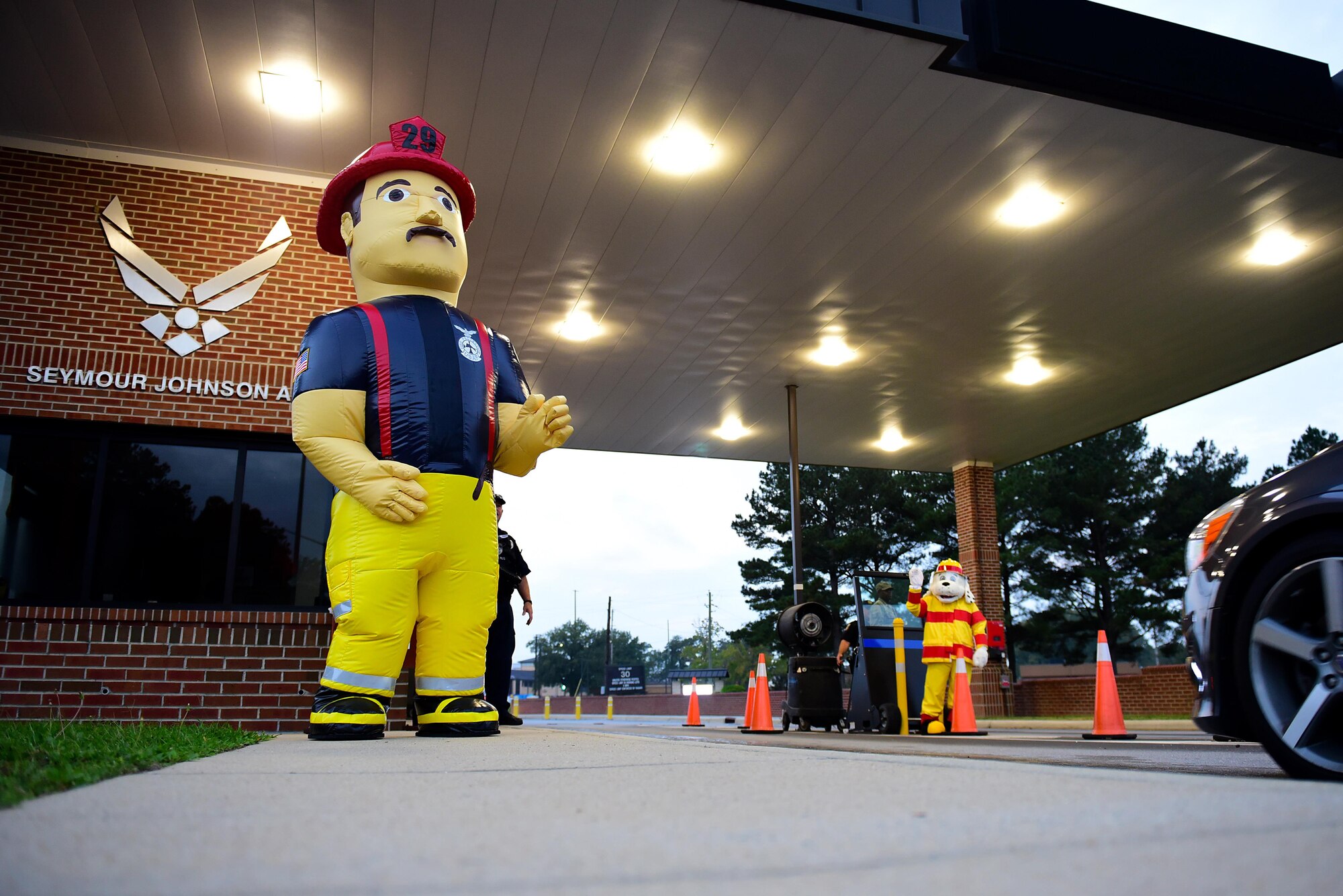 Big Bob and Sparky the Fire Dog greet members of Team Seymour as they arrive at the Oak Forest Gate, Oct. 11, 2017, at Seymour Johnson Air Force Base, North Carolina. According to the National Fire Protection Association, in 2015, an estimated 365,000 home structure fires caused 2,560 deaths, 11,075 civilian injuries, and $7 billion in damage. (U.S. Air Force photo by Airman 1st Class Kenneth Boyton)