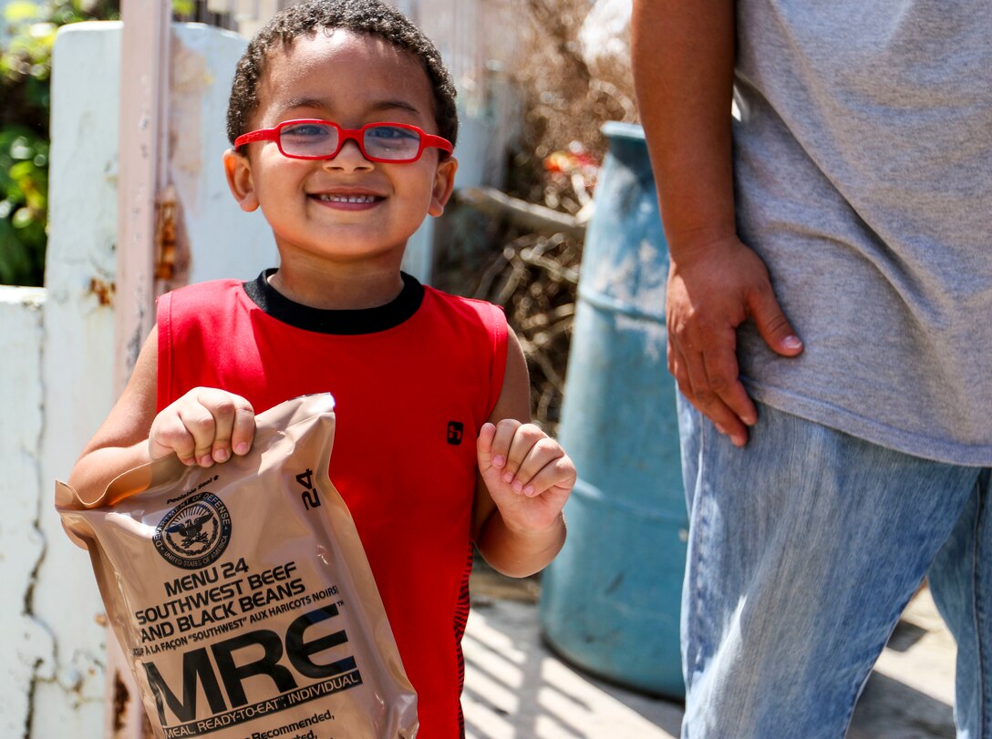 A boy smiles after receiving a packaged meal in San Juan, Puerto Rico.