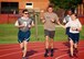 At center, Command Chief Master Sgt. Chad Welch smiles as he leads a group of Air Force Reserve Command reservists around the Scott Air Force Base track for a fitness run Oct. 14, 2017, at Scott Air Force Base, Ill. Pushups, situps, and the run are emphasized throughout the year and encouraged with additional 