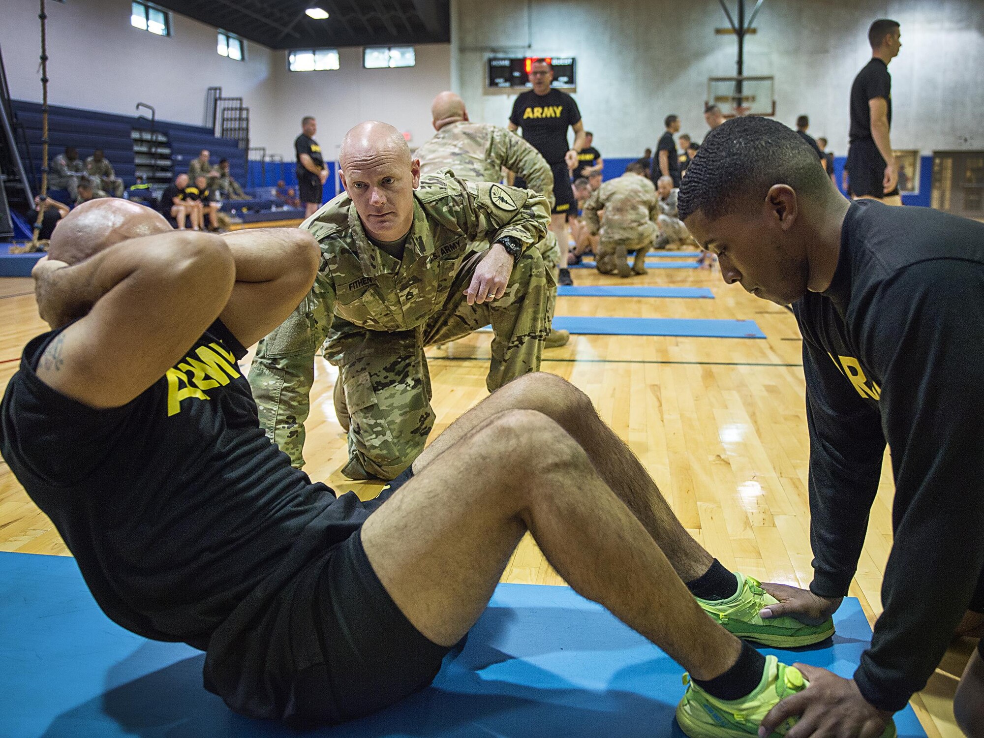 Sergeant First Class Douglas Fithen, from the Indiana National Guard Recruiting and Retention Battalion, counts sit-ups for a Soldier Oct. 13, 2017 at the Grissom Fitness Center. The Army Recruiters took physical fitness tests using Grissom’s facilities during a conference they held on base. (U.S. Air Force photo/Senior Airman Harrison Withrow)