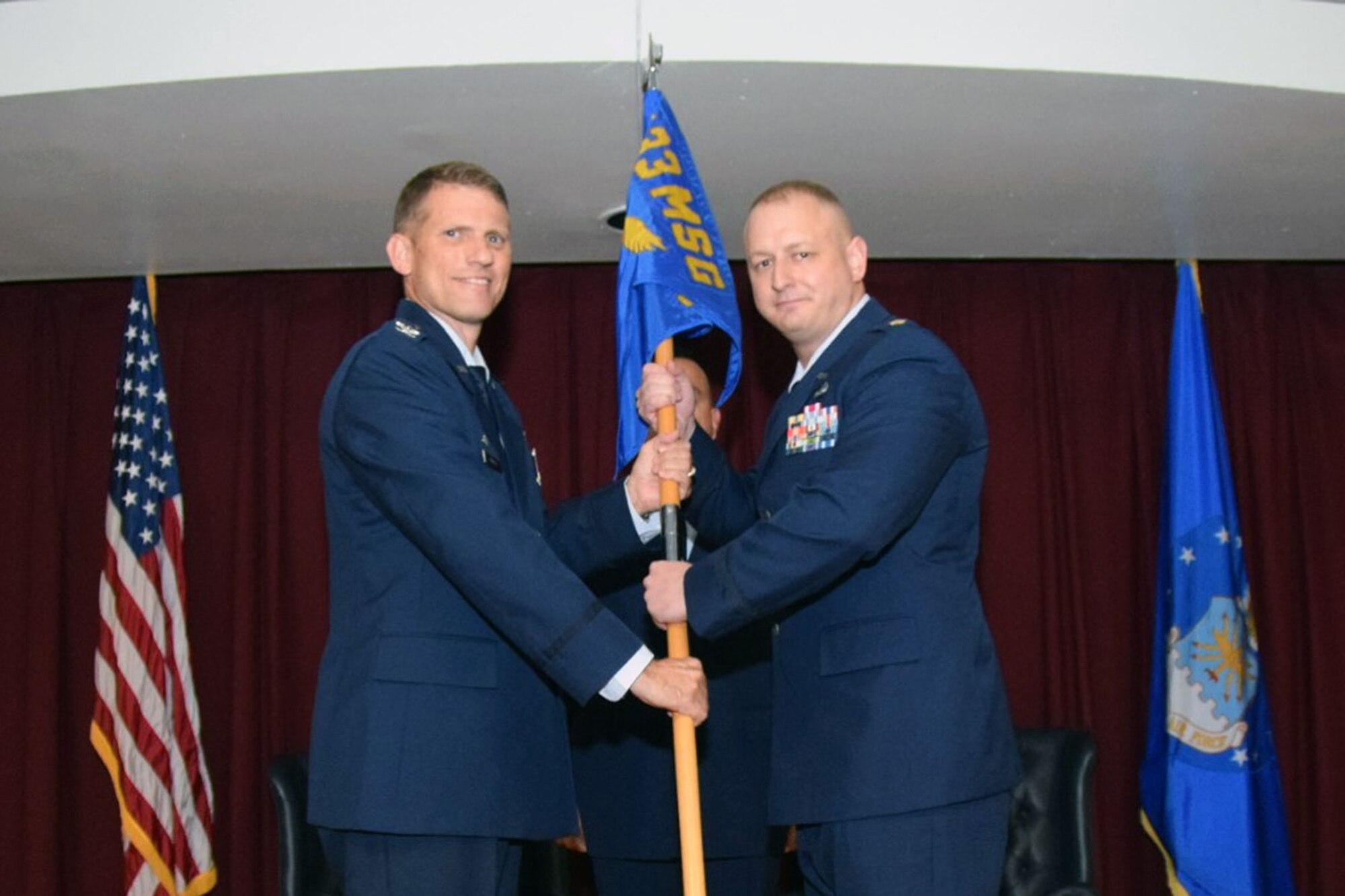 Col. David Enfield, 433rd Mission Support Group commander, hands over the guidon of leadership to Maj. Matthew F. Darisse at an assumption of command ceremony held Oct. 14, 2017. Maj. Darisse started his career as an enlisted Airman in 2003. (Air Force photo by Tech. Sgt. Carlos J. Trevino)