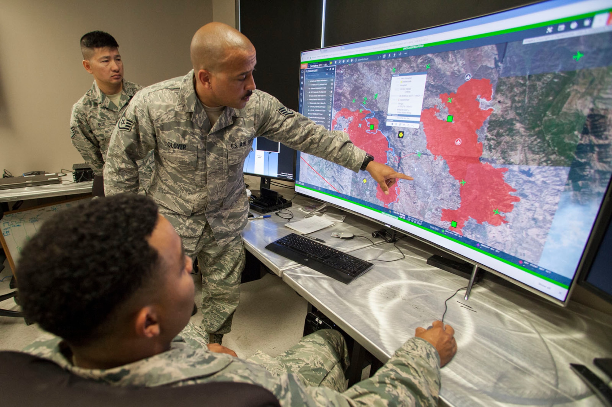 Staff Sgt. Richard Glover, 163d Attack Wing IT Specialist, shows burn areas to Staff Sgt. Jamel Seales (sitting) and Staff Sgt. Shawn Blue (background) on Saturday, Oct. 14, 2017, at the wing's Hap Arnold Center at March Air Reserve Base, California.