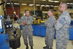 Tech. Sgt. John Gonzalez, 433rd Maintenance Squadron structural maintenance technician, demonstrates to 4th Air Force leadership how the technology available to his shop helps improve practices and increases production.  Maj. Gen. Randall Ogden, 4th Air Force commander, and Chief Master Sgt. Timothy White, Jr., 4th AF command chief, were visiting squadrons within the 433rd Maintenance Group Oct. 15, 2017 during their four-day visit to the Alamo Wing. (U.S. Air Force photo/Senior Airman Bryan Swink)