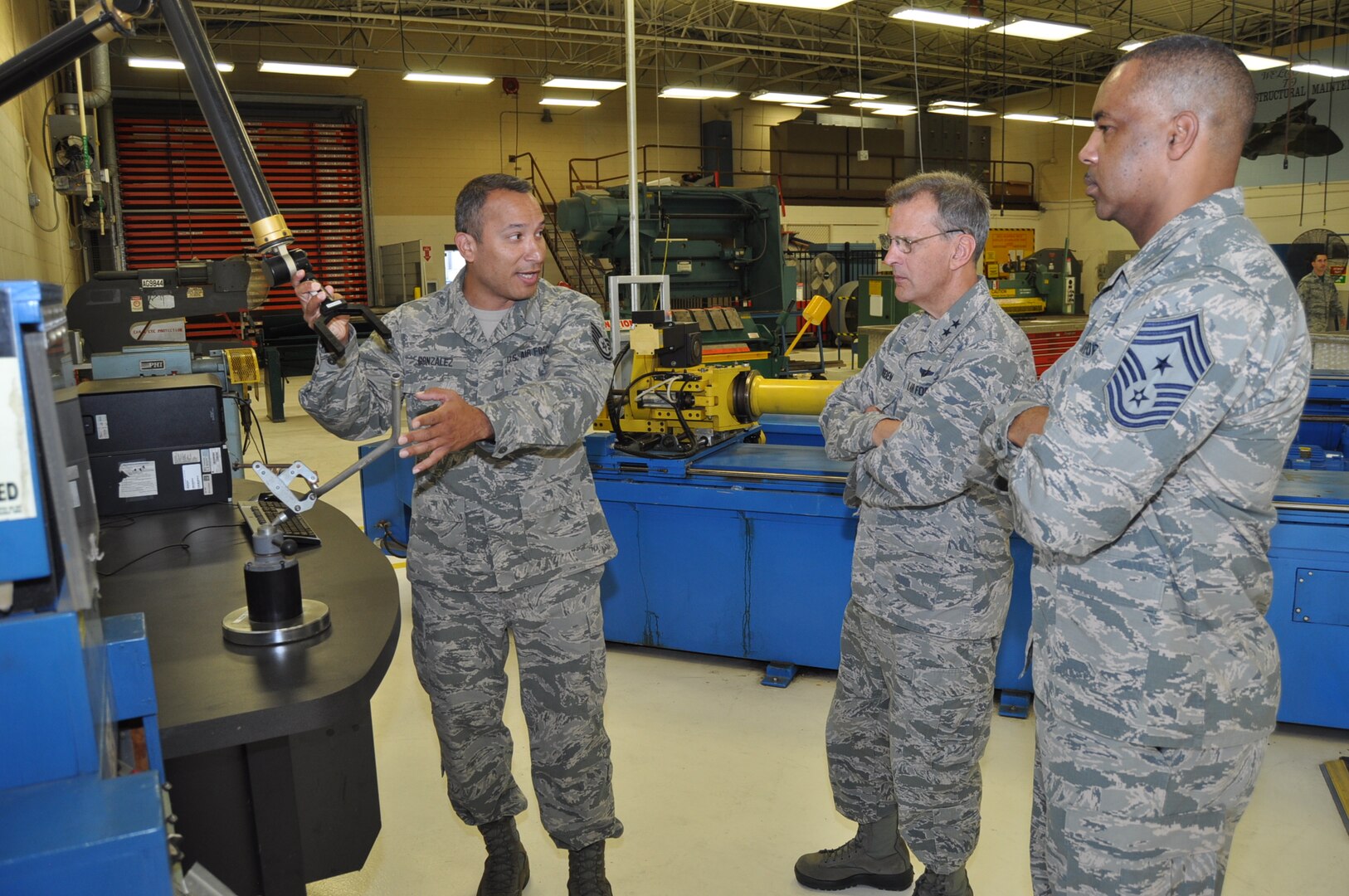 Tech. Sgt. John Gonzalez, 433rd Maintenance Squadron structural maintenance technician, demonstrates to 4th Air Force leadership how the technology available to his shop helps improve practices and increases production.  Maj. Gen. Randall Ogden, 4th Air Force commander, and Chief Master Sgt. Timothy White, Jr., 4th AF command chief, were visiting squadrons within the 433rd Maintenance Group Oct. 15, 2017 during their four-day visit to the Alamo Wing. (U.S. Air Force photo/Senior Airman Bryan Swink)