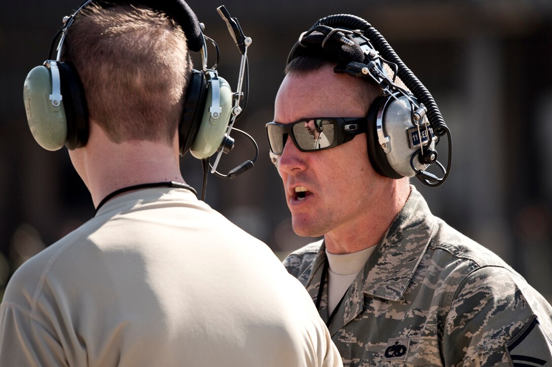 U.S. Air Force Reserve Master Sgt. Benjamin Hamilton, production supervisor, 913th Maintenance Squadron, provides instruction on an Aircraft Marshaller’s positioning to Senior Airman Steven Firmin, 913 MXS, during an engine-running onload/offload (ERO) Oct. 14, 2017, at Little Rock Air Force Base, Ark.