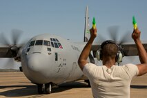 U.S. Air Force Reserve Maj. Julie Honeycutt, pilot, 327th Airlift Squadron, reacts to Senior Airman Edward Hunter, crew chief, 913th Maintenance Squadron, as he marshals in the C-130J Super Hercules Oct. 14, 2017, at Little Rock Air Force Base, Ark.