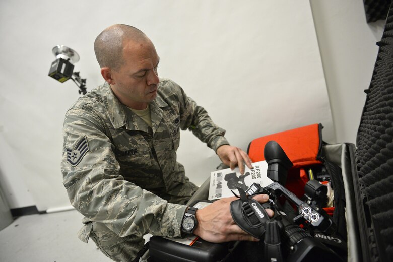 U.S. Airman Staff Sgt. Brian Jarvis, broadcaster, 129th Rescue Wing, Moffett Air National Guard Base, Calif., checks over his camera gear in preparation for an overseas deployment, October 15, 2017. (U.S. Air National Guard photo by Master Sgt. Ray Aquino/released)