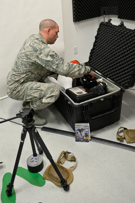 U.S. Airman Staff Sgt. Brian Jarvis, broadcaster, 129th Rescue Wing, Moffett Air National Guard Base, Calif., checks over his camera gear in preparation for an overseas deployment, October 15, 2017. (U.S. Air National Guard photo by Master Sgt. Ray Aquino/released)