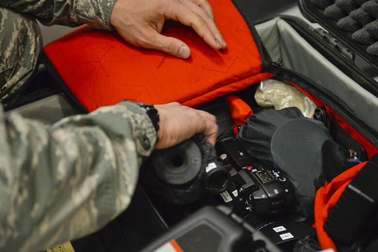 U.S. Airman Staff Sgt. Brian Jarvis, broadcaster, 129th Rescue Wing, Moffett Air National Guard Base, Calif., checks over his camera gear in preparation for an overseas deployment, October 15, 2017. (U.S. Air National Guard photo by Master Sgt. Ray Aquino/released)