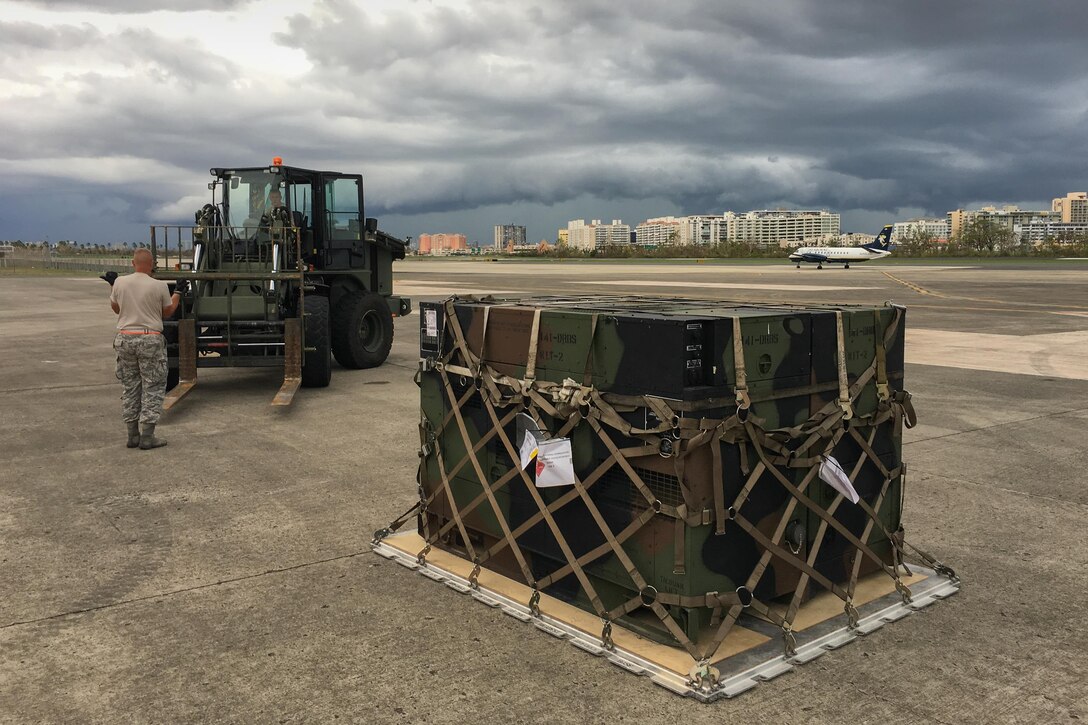 Airmen from the Kentucky Air National Guard’s 123rd Contingency Response Group, augmented by troops from the active-duty Air Force and Air National Guard units in multiple states, dowload relief supplies from aircraft around the clock at Luis Muñoz Marín International Airport in San Juan, Puerto Rico, in the wake of Hurricane Maria Oct. 5, 2017. The unit’s Airmen established an aerial port of debarkation upon arrival here Sept. 23, and have processed more than 7.2 million pounds of cargo and humanitarian aid for distribution in the first three weeks of the operation. (U.S. Air National Guard photo by Lt. Col. Dale Greer)
