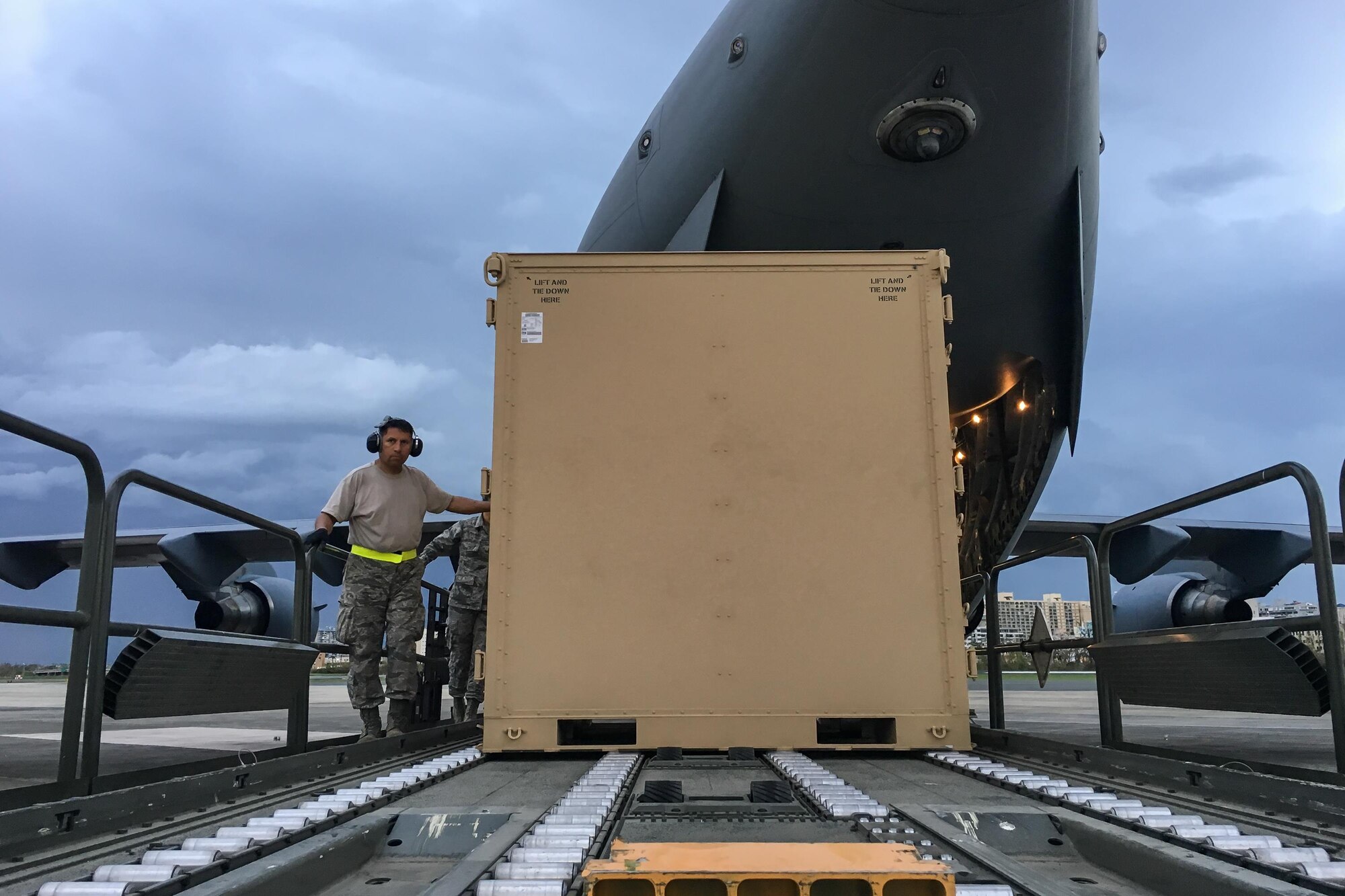 An Airman from the Kentucky Air National Guard’s 123rd Contingency Response Group dowloads relief supplies from a U.S. Air Force C-17 aircraft at Luis Muñoz Marín International Airport in San Juan, Puerto Rico, in the wake of Hurricane Maria Oct. 5, 2017. The unit’s Airmen established an aerial port of debarkation upon arrival here Sept. 23, and have processed more than 7.2 million pounds of cargo and humanitarian aid for distribution in the first three weeks of the operation. (U.S. Air National Guard photo by Lt. Col. Dale Greer)