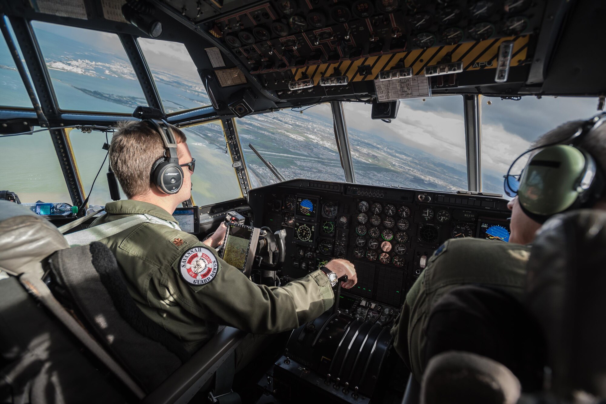 A C-130 aircrew from the Georgia Air National Guard’s 165th Airlift Wing approaches Puerto Rico with a load of humanitarian aid being flown from Savannah, Ga., to Luis Muñoz Marín International Airport in San Juan on Oct. 5, 2017. The cargo will be downloaded and staged for distribution by Airmen from the Kentucky Air Guard’s 123rd Contingency Response Group as part of Hurricane Maria recovery efforts. (U.S. Air National Guard photo by Lt. Col. Dale Greer)