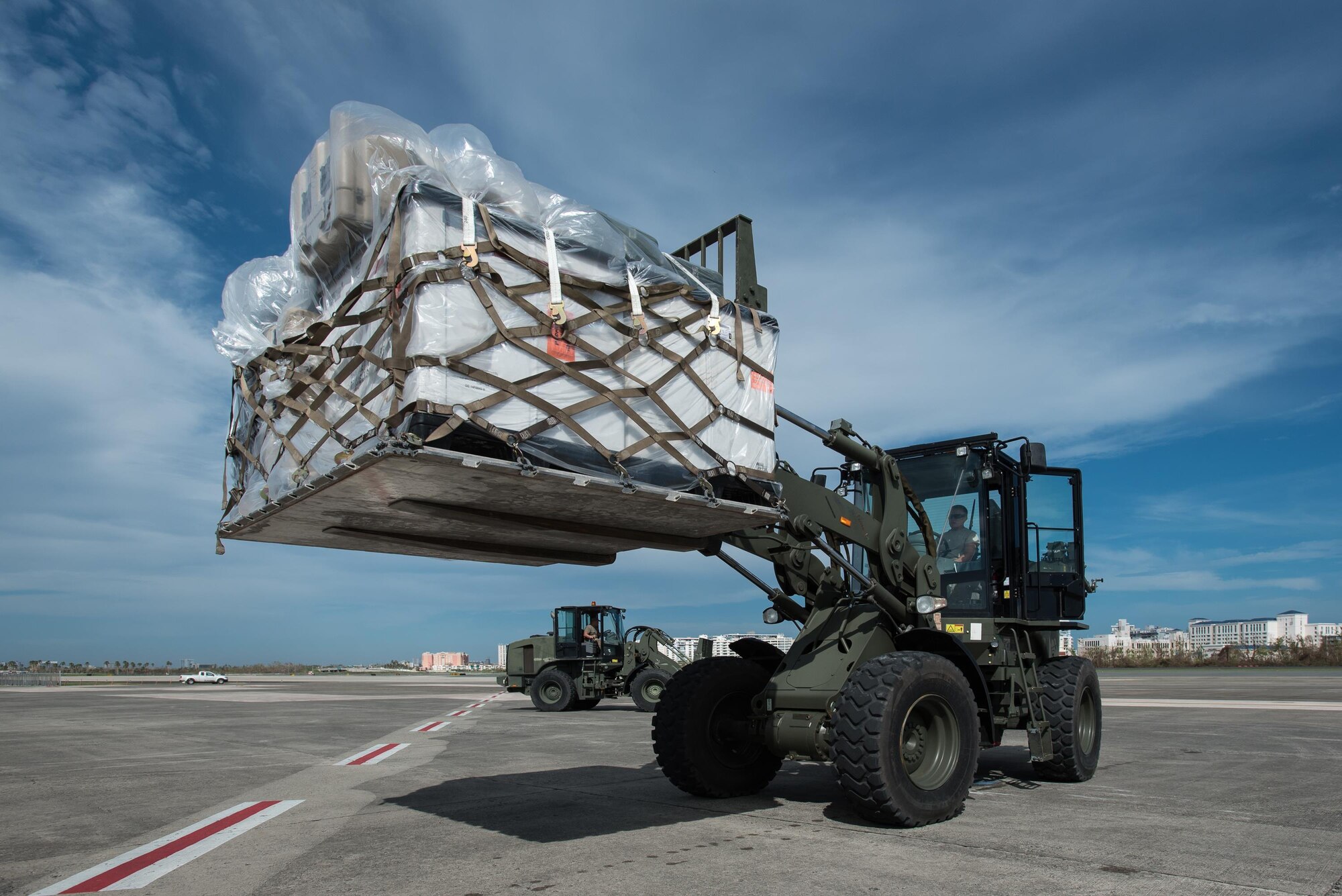 Airmen from the Kentucky Air National Guard’s 123rd Contingency Response Group, augmented by troops from the active-duty Air Force and Air National Guard units in multiple states, dowload relief supplies from aircraft around the clock at Luis Muñoz Marín International Airport in San Juan, Puerto Rico, in the wake of Hurricane Maria Oct. 6, 2017. The unit’s Airmen established an aerial port of debarkation upon arrival here Sept. 23, and have processed more than 7.2 million pounds of cargo and humanitarian aid for distribution in the first three weeks of the operation. (U.S. Air National Guard photo by Lt. Col. Dale Greer)