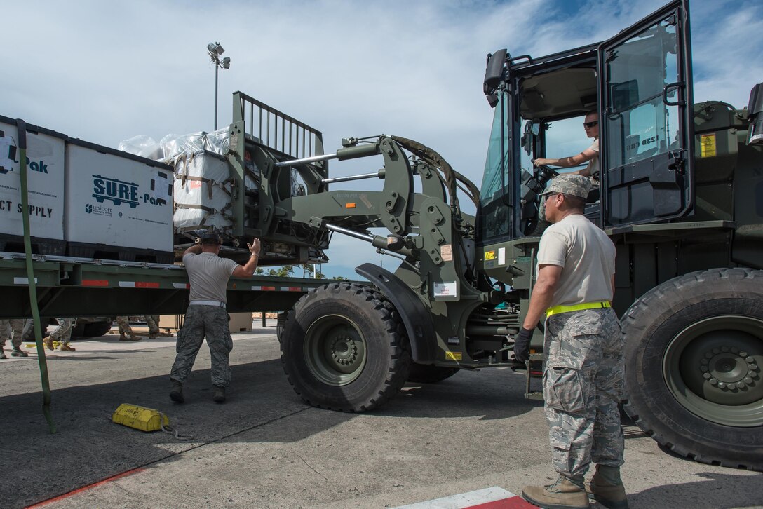 Airmen from the Kentucky Air National Guard’s 123rd Contingency Response Group, augmented by troops from the active-duty Air Force and Air National Guard units in multiple states, load relief supplies onto trucks for distribution at Luis Muñoz Marín International Airport in San Juan, Puerto Rico, in the wake of Hurricane Maria Oct. 6, 2017. The unit’s Airmen established an aerial port of debarkation upon arrival here Sept. 23, and have processed more than 7.2 million pounds of cargo and humanitarian aid for distribution in the first three weeks of the operation. (U.S. Air National Guard photo by Lt. Col. Dale Greer)