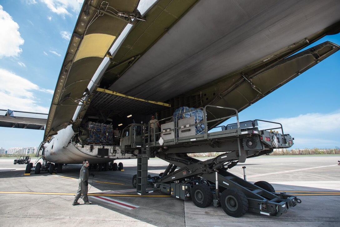 Airmen from the Kentucky Air National Guard’s 123rd Contingency Response Group, augmented by troops from the active-duty Air Force and Air National Guard units in multiple states, dowload relief supplies from aircraft around the clock at Luis Muñoz Marín International Airport in San Juan, Puerto Rico, in the wake of Hurricane Maria Oct. 6, 2017. The unit’s Airmen established an aerial port of debarkation upon arrival here Sept. 23, and have processed more than 7.2 million pounds of cargo and humanitarian aid for distribution in the first three weeks of the operation. (U.S. Air National Guard photo by Lt. Col. Dale Greer)