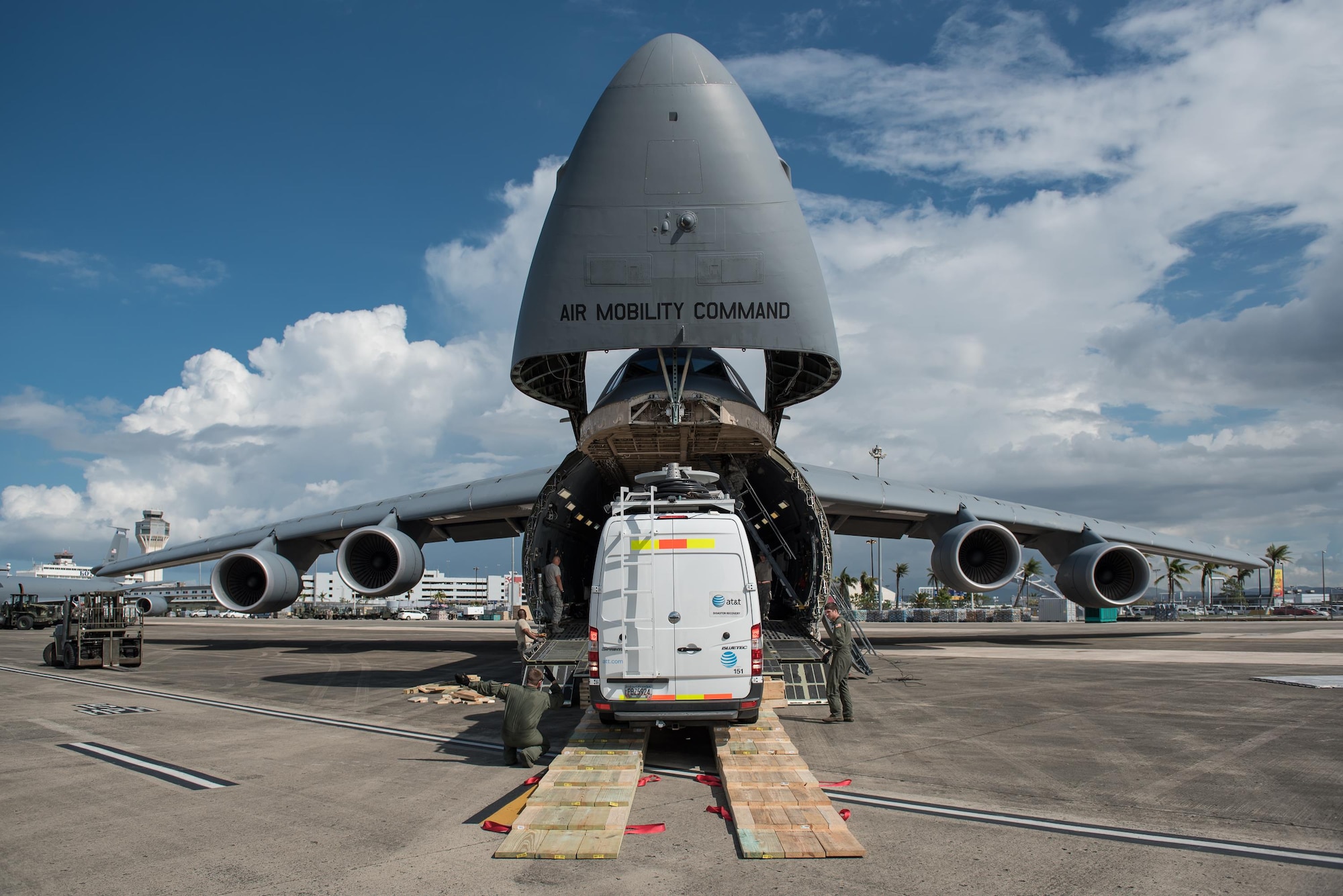 Members of the Kentucky Air National Guard’s 123rd Contingency Response Group, augmented by Airmen from the active-duty Air Force and Air National Guard units in multiple states, download a mobile cell-phone tower truck from a U.S. Air Force C-5 Galaxy at Luis Muñoz Marín International Airport in San Juan, Puerto Rico, in the wake of Hurricane Maria Oct. 6, 2017. The truck will be used to help restore cell-phone service on the island. (U.S. Air National Guard photo by Lt. Col. Dale Greer)