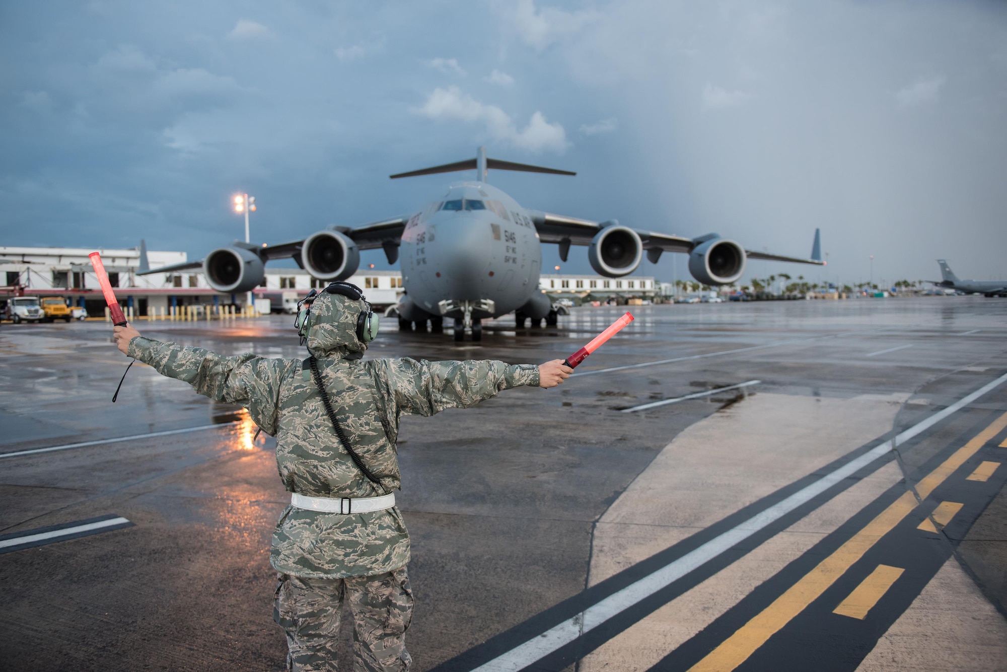 An Airman from the Kentucky Air National Guard’s 123rd Contingency Response Group parks a U.S. Air Force C-17 Globemaster III at Luis Muñoz Marín International Airport in San Juan, Puerto Rico, on Oct. 6, 2017. The aircraft is carrying relief supplies to assist with recovery efforts following Hurricane Maria. (U.S. Air National Guard photo by Lt. Col. Dale Greer)