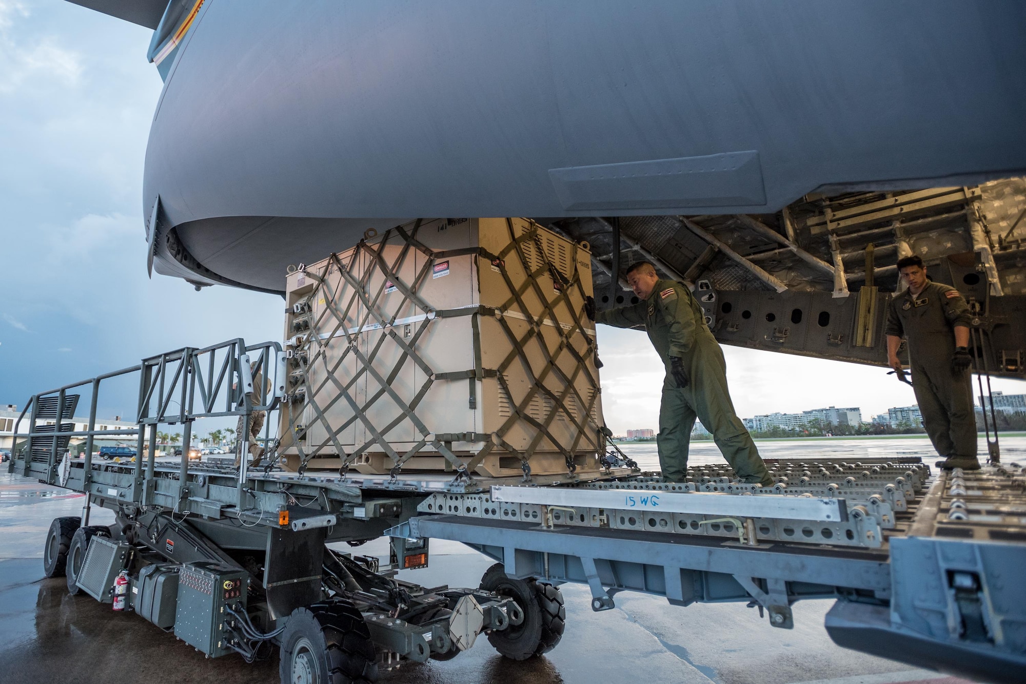 Loadmasters from the Hawaii Air National Guard dowload relief supplies from their C-17 aircraft at Luis Muñoz Marín International Airport in San Juan, Puerto Rico, in the wake of Hurricane Maria Oct. 6, 2017. An aerial port of debarkation at the airport has processed more than 7.2 million pounds of cargo and humanitarian aid since Sept. 23. (U.S. Air National Guard photo by Lt. Col. Dale Greer)