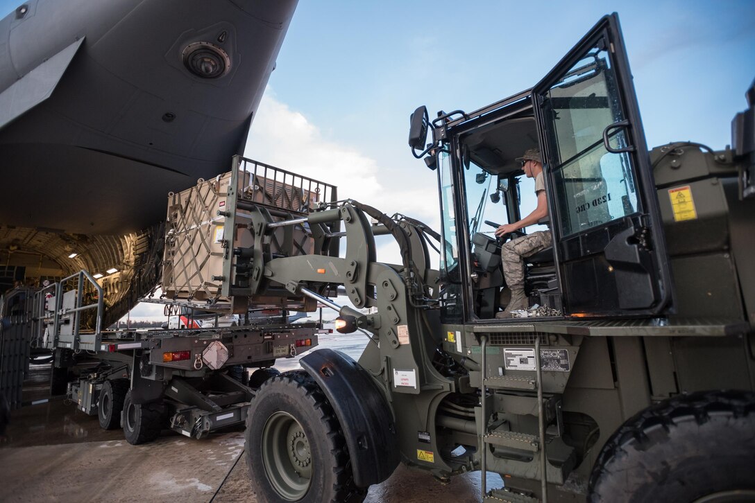 Airmen from the Kentucky Air National Guard’s 123rd Contingency Response Group, augmented by troops from the active-duty Air Force and Air National Guard units in multiple states, dowload relief supplies from aircraft around the clock at Luis Muñoz Marín International Airport in San Juan, Puerto Rico, in the wake of Hurricane Maria Oct. 6, 2017. The unit’s Airmen established an aerial port of debarkation upon arrival here Sept. 23, and have processed more than 7.2 million pounds of cargo and humanitarian aid for distribution in the first three weeks of the operation. (U.S. Air National Guard photo by Lt. Col. Dale Greer)