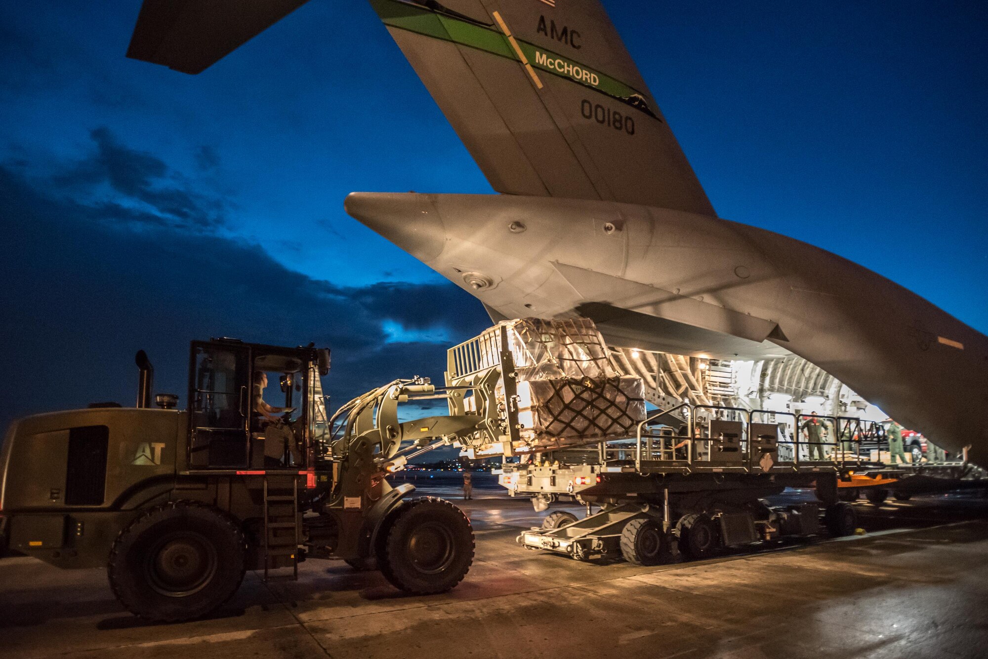 Airmen from the Kentucky Air National Guard’s 123rd Contingency Response Group, augmented by troops from the active-duty Air Force and Air National Guard units in multiple states, dowload relief supplies from aircraft around the clock at Luis Muñoz Marín International Airport in San Juan, Puerto Rico, in the wake of Hurricane Maria Oct. 6, 2017. The unit’s Airmen established an aerial port of debarkation upon arrival here Sept. 23, and have processed more than 7.2 million pounds of cargo and humanitarian aid for distribution in the first three weeks of the operation. (U.S. Air National Guard photo by Lt. Col. Dale Greer)