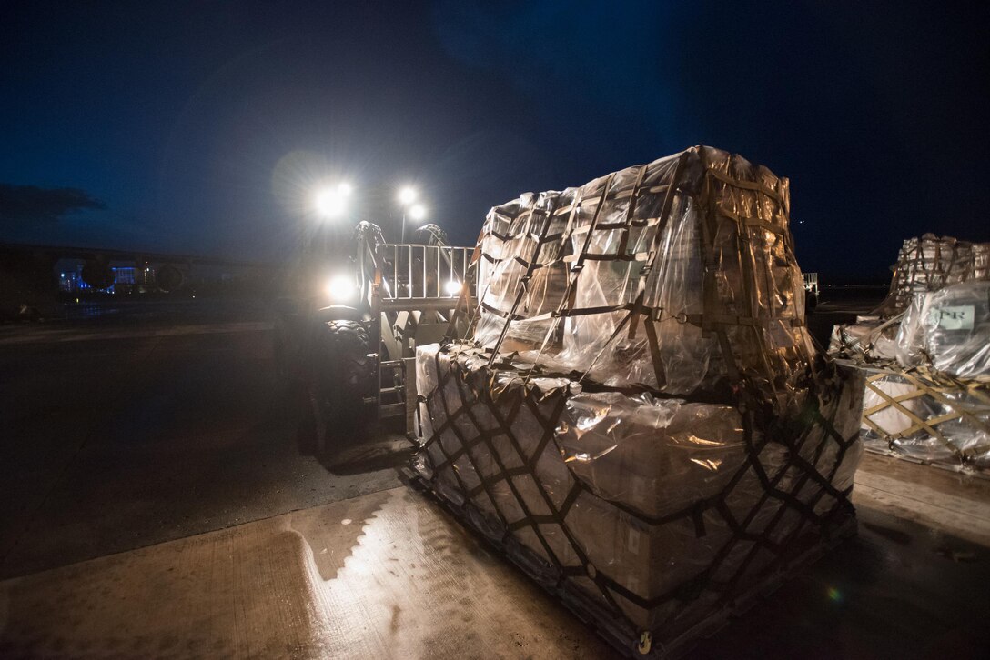 Airmen from the Kentucky Air National Guard’s 123rd Contingency Response Group, augmented by troops from the active-duty Air Force and Air National Guard units in multiple states, dowload relief supplies from aircraft around the clock at Luis Muñoz Marín International Airport in San Juan, Puerto Rico, in the wake of Hurricane Maria Oct. 6, 2017. The unit’s Airmen established an aerial port of debarkation upon arrival here Sept. 23, and have processed more than 7.2 million pounds of cargo and humanitarian aid for distribution in the first three weeks of the operation. (U.S. Air National Guard photo by Lt. Col. Dale Greer)