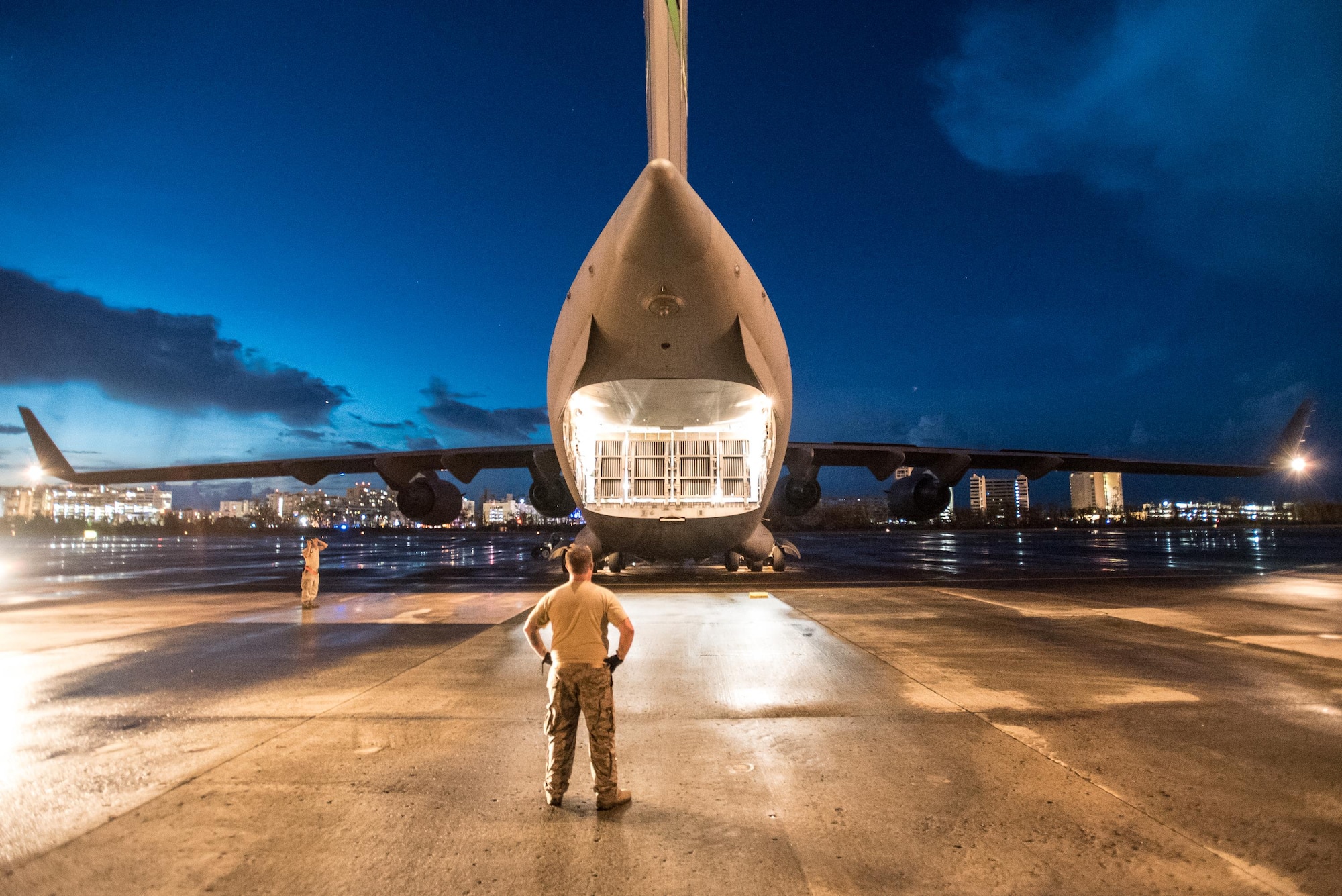 An Airman from the Kentucky Air National Guard’s 123rd Contingency Response Group waits to dowload relief supplies from a U.S. Air Force C-17 at Luis Muñoz Marín International Airport in San Juan, Puerto Rico, in the wake of Hurricane Maria Oct. 6, 2017. The unit’s Airmen established an aerial port of debarkation upon arrival here Sept. 23, and have processed more than 7.2 million pounds of cargo and humanitarian aid for distribution in the first three weeks of the operation. (U.S. Air National Guard photo by Lt. Col. Dale Greer)