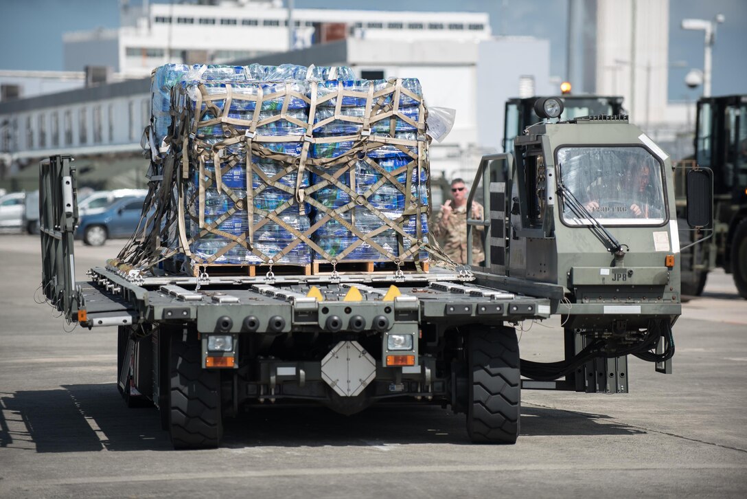 Airmen from the Kentucky Air National Guard’s 123rd Contingency Response Group, augmented by troops from the active-duty Air Force and Air National Guard units in multiple states, dowload relief supplies from aircraft around the clock at Luis Muñoz Marín International Airport in San Juan, Puerto Rico, in the wake of Hurricane Maria Oct. 6, 2017. The unit’s Airmen established an aerial port of debarkation upon arrival here Sept. 23, and have processed more than 7.2 million pounds of cargo and humanitarian aid for distribution in the first three weeks of the operation. (U.S. Air National Guard photo by Lt. Col. Dale Greer)