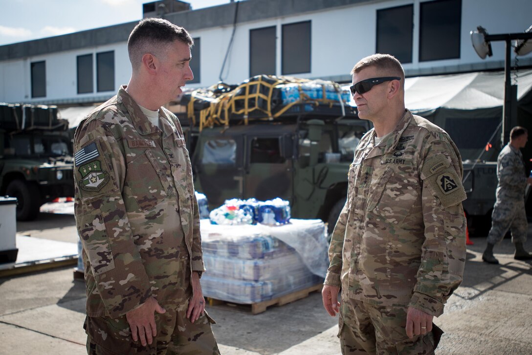 Col. Bruce Bancroft (left), commander of the Kentucky Air National Guard’s 123rd Contingency Response Group, discusses Hurricane Maria relief operations at Luis Muñoz Marín International Airport in San Juan, Puerto Rico, with Army Lt. Gen. Jeffrey Buchanan, commander of United States Army North, on Oct. 7, 2017. An aerial port operated by the Guardsmen has processed more than 7.2 million pounds of humanitarian aid since Sept. 23. (U.S. Air National Guard photo by Lt. Col. Dale Greer)