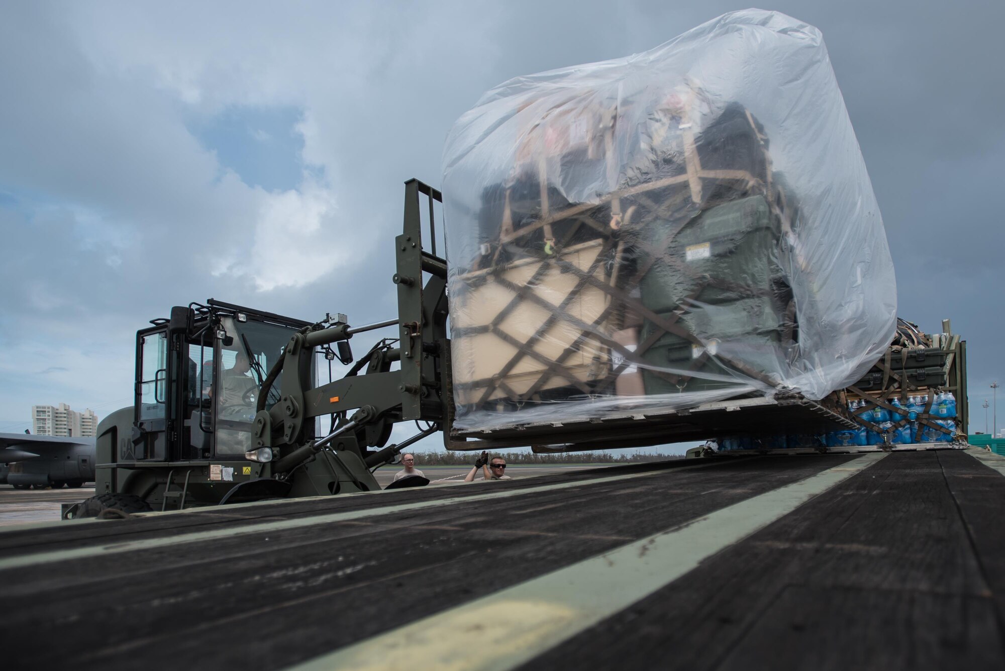 Airmen from the Kentucky Air National Guard’s 123rd Contingency Response Group, augmented by troops from the active-duty Air Force and Air National Guard units in multiple states, load relief supplies onto trucks for distribution at Luis Muñoz Marín International Airport in San Juan, Puerto Rico, in the wake of Hurricane Maria Oct. 7, 2017. The unit’s Airmen established an aerial port of debarkation upon arrival here Sept. 23, and have processed more than 7.2 million pounds of cargo and humanitarian aid for distribution in the first three weeks of the operation. (U.S. Air National Guard photo by Lt. Col. Dale Greer)