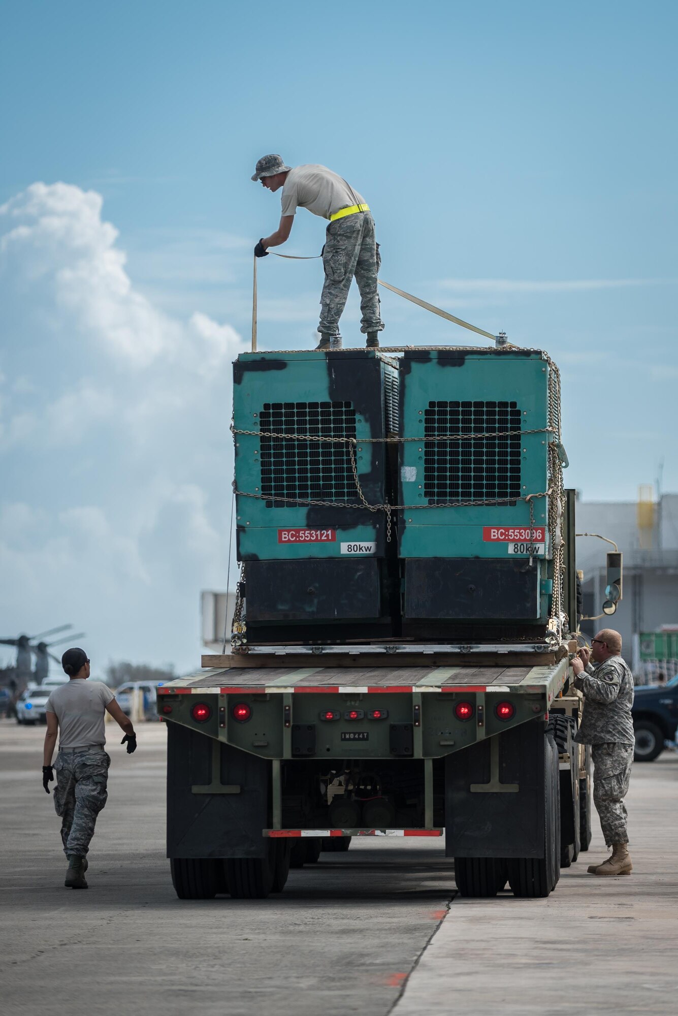 An aerial porter from the Nevada Air National Guard straps an electric generator to a flat-bed truck Oct. 7, 2017, at Luis Muñoz Marín International Airport in San Juan, Puerto Rico. The generator will be used to assist with relief operations on the island following Hurricane Maria. (U.S. Air National Guard photo by Lt. Col. Dale Greer)