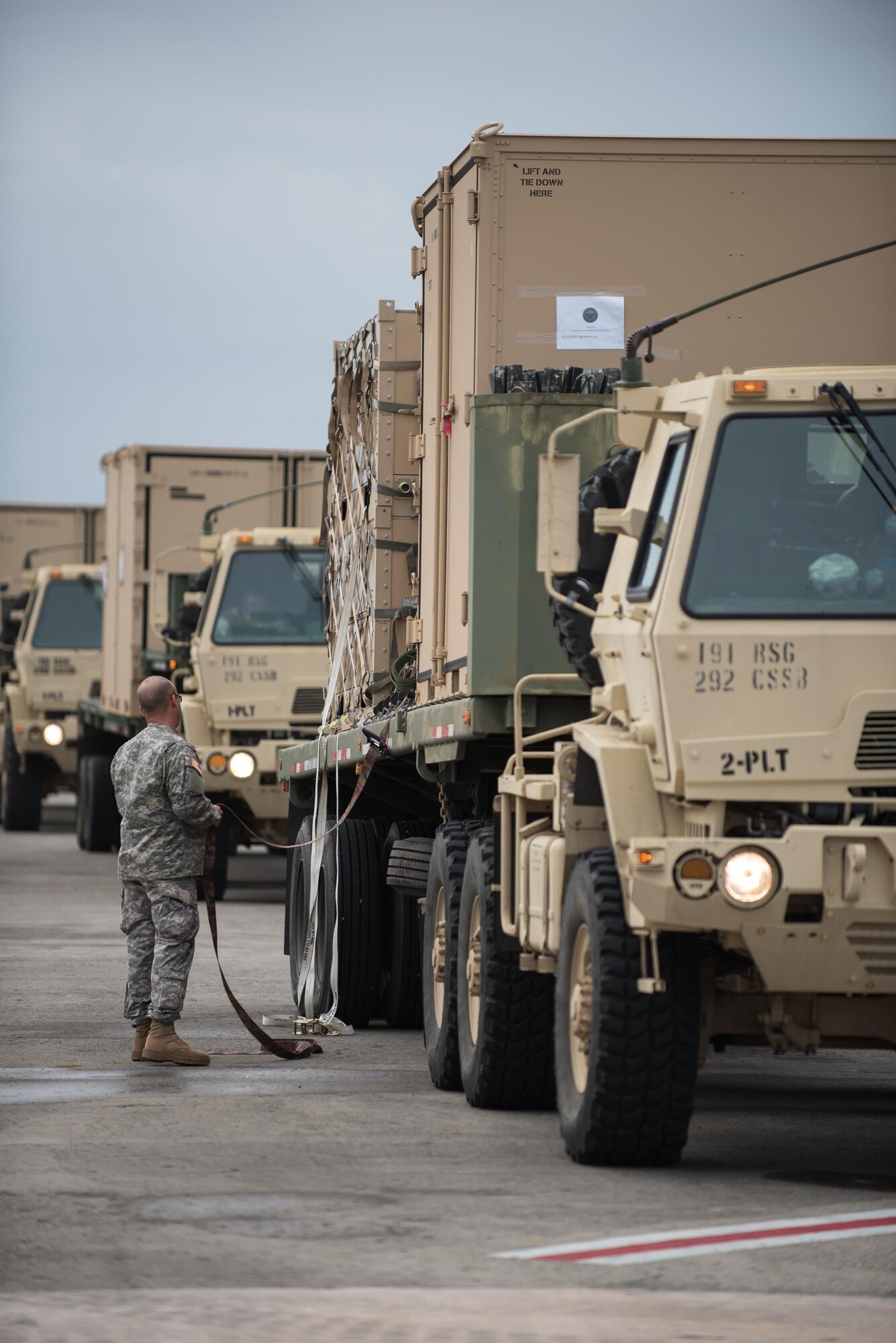 A Soldier from the Puerto Rico Army National Guard’s 755th Transportation Command straps pallets of relief supplies to a flat-bed trailer at Luis Muñoz Marín International Airport in San Juan, Puerto Rico, on Oct. 7, 2017. The cargo will be used for recovery operations following Hurricane Maria. (U.S. Air National Guard photo by Lt. Col. Dale Greer)