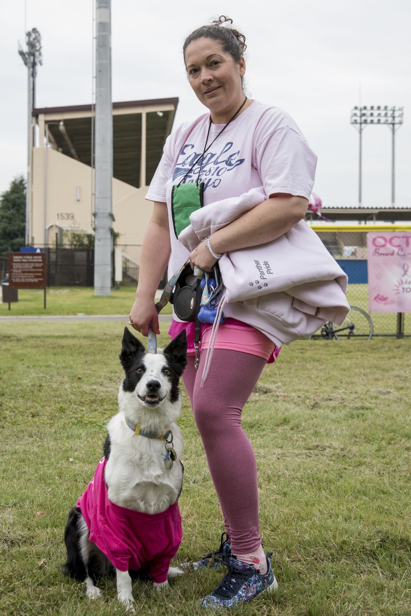 Deanna Melin poses for a picture with her dog during the Breast Cancer Awareness Month 5K run at Yokota Air Base, Japan, Oct. 06, 2017.