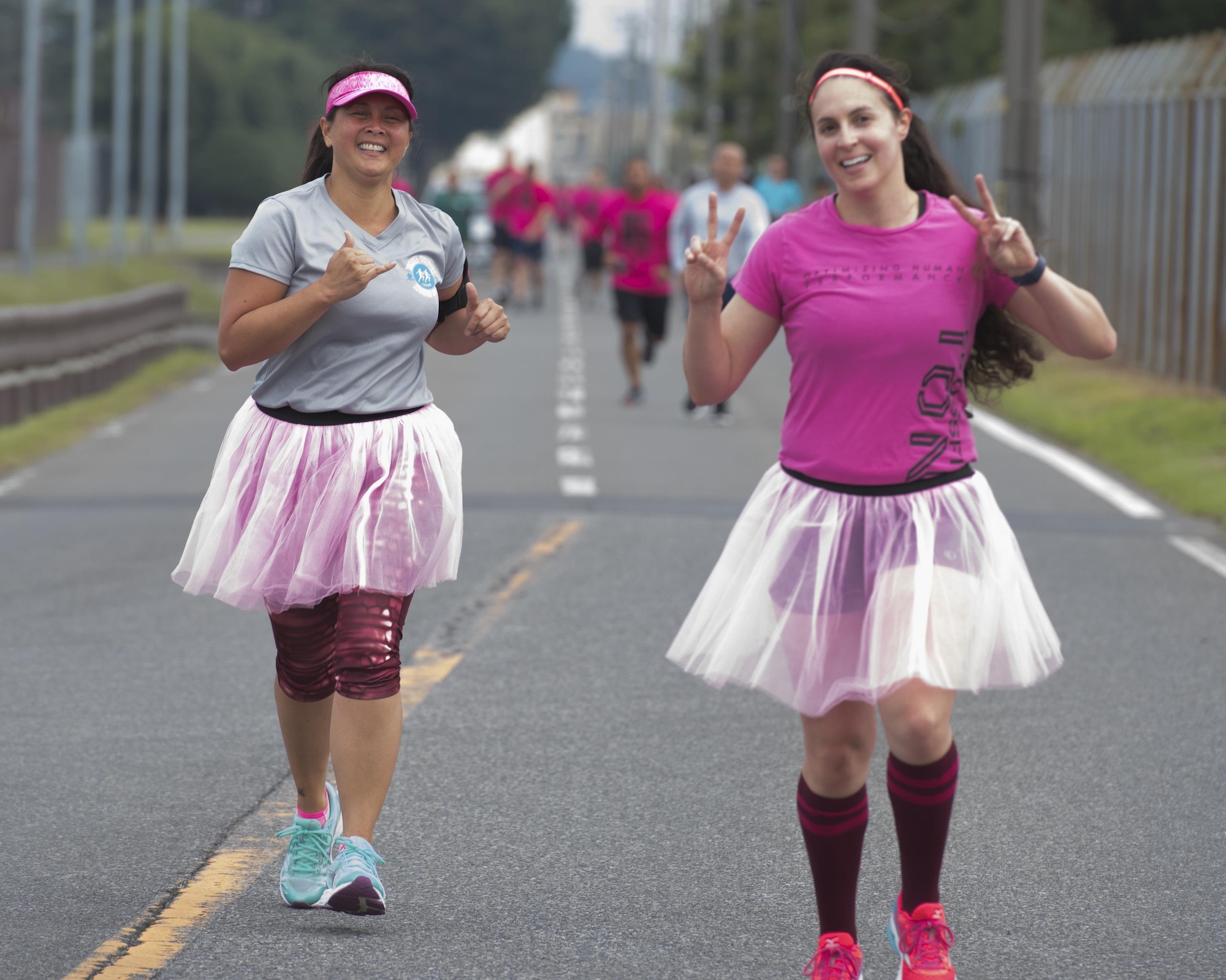 A participants poses for a picture while running during the Breast Cancer Awareness Month 5K run at Yokota Air Base, Japan, Oct. 06, 2017.