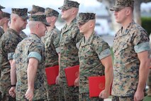 Colonel David M. Fallon, the 9th Marine Corps District commanding officer, presents awards to Marines during the Operation Herculean Effort ceremony in San Diego, Calif., Oct. 11. The ceremony was conducted in order to recognize the Marine recruiters from the 9th MCD, who went above and beyond in finding the most highly qualified men and women to join its ranks during the two-month recruiting offensive. Marines received awards, such as the Navy and Marine Corps Commendation and the Navy and Marine Corps Achievement Medals. (U.S. Marine Corps photo by Lance Cpl. Quavaungh Pointer)