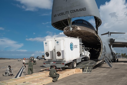Members of the Kentucky Air National Guard’s 123rd Contingency Response Group, augmented by Airmen from the active-duty Air Force and Air National Guard units in multiple states, download a mobile cell-phone tower truck from a U.S. Air Force C-5 Galaxy at Luis Muñoz Marín International Airport in San Juan, Puerto Rico, in the wake of Hurricane Maria Oct. 6, 2017. The truck will be used to help restore cell-phone service on the island. (U.S. Air National Guard photo by Lt. Col. Dale Greer)