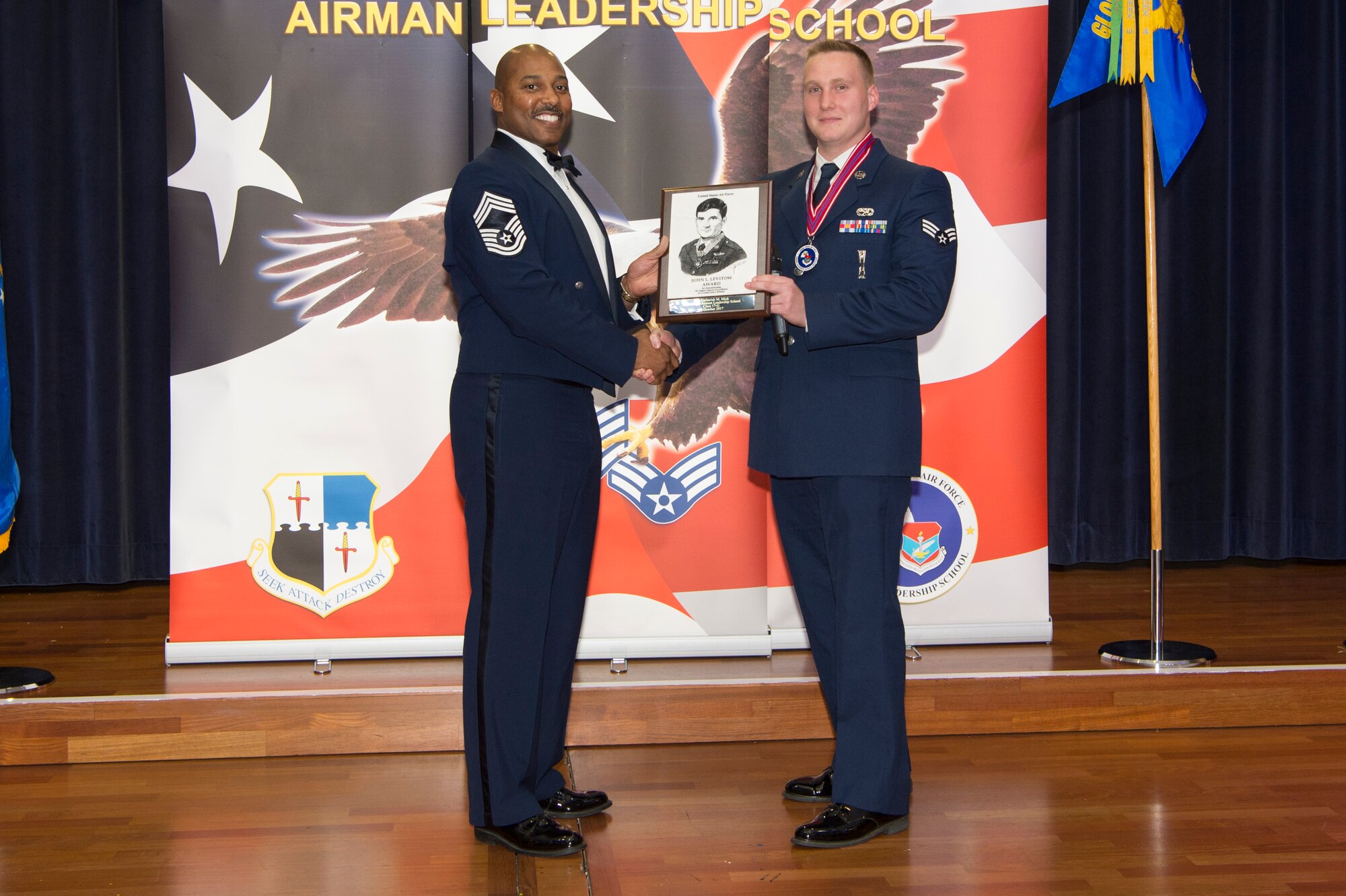 U.S. Air Force Staff Sgt. Zachariah Mick, 52nd Maintenance Squadron munitions controller, receives the John L. Levitow during the Pitsenbarger Airman Leadership School 17-G graduation at Club Eifel on Spangdahlem Air Base, Germany, October 12, 2017. The Levitow award is the highest honor given to the student who displays excellence in all categories of ALS. (U.S. Air Force photo by Senior Airman Dawn M. Weber)