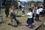 U.S. Marine Lance Cpl. Trai Pelletier, a welder with the Logistics Combat Element, Special Purpose Marine Air-Ground Task Force - Southern Command, greets a child at the ribbon cutting ceremony for the Taufick Bendeck Elementary School in Trujillo, Honduras, July 27, 2017. The Marines are conducting infrastructure improvement projects at local schools in Trujillo at the request of the government of Honduras. The Marines and sailors of SPMAGTF-SC are deployed to Central America to conduct security cooperation training and engineering projects with their counterparts in several Central American and Caribbean nations.