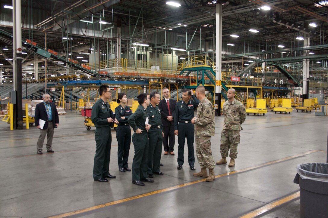 Republic of Korea Army Logistics Command commanding general Lt. Gen. Lee, Jeong Keun, center, and several other ROK ALC representatives tour DLA Distribution Susquehanna, Pa.’s Eastern Distribution Center, the largest distribution center within the Department of Defense.