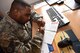 Tech. Sgt. Rashid Watts, 86th Airlift Wing Combined Federal Campaign community project officer, fills out a pledge form for the CFC at Ramstein Air Base, Germany on Oct. 12, 2017. The primary goal of this year’s CFC is to make 100 percent contact with federal employees and their families to raise awareness about the program.